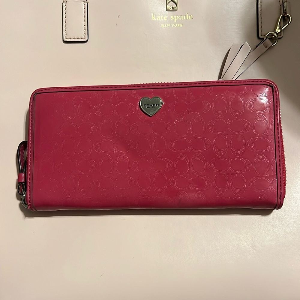 Pink coach wallet. Does have an area of discoloration-in second photo.